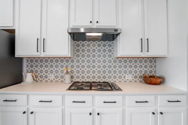 a kitchen with a sink a counter and cabinets