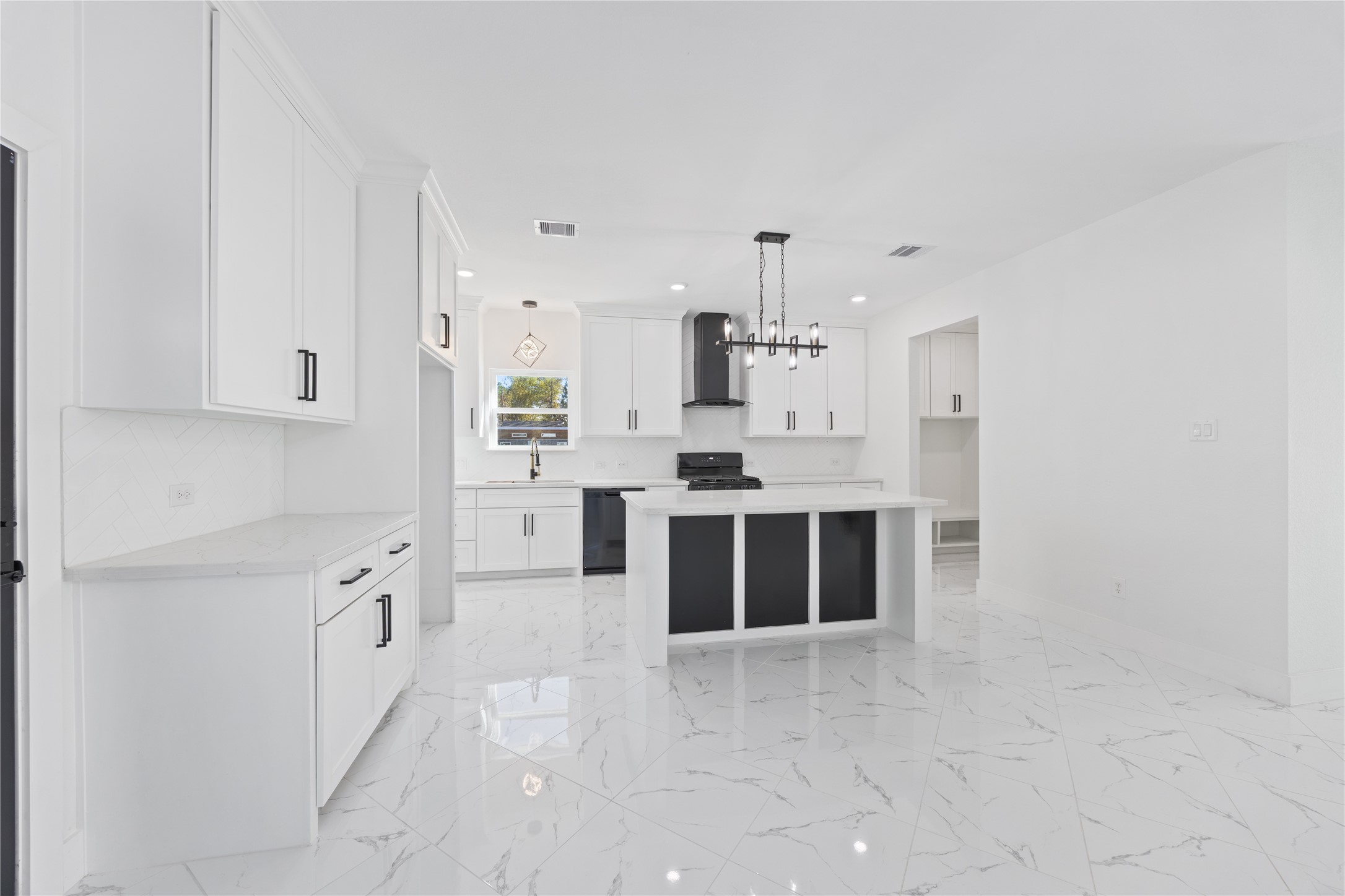 6063 Townsan Road Houston, TX 77396 - Photo 14 of 46 a large white kitchen with cabinets and stainless steel appliances