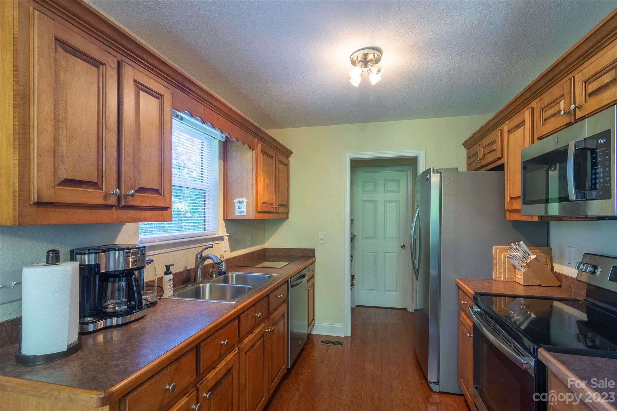 125 Parris Field Road Bryson City, NC 28713 - Photo 11 of 25 a kitchen with stainless steel appliances granite countertop a stove a sink and a refrigerator