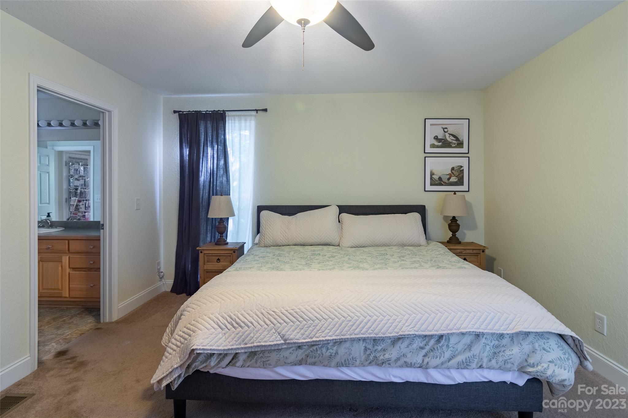 125 Parris Field Road Bryson City, NC 28713 - Photo 14 of 25 a bedroom with a bed and a chandelier