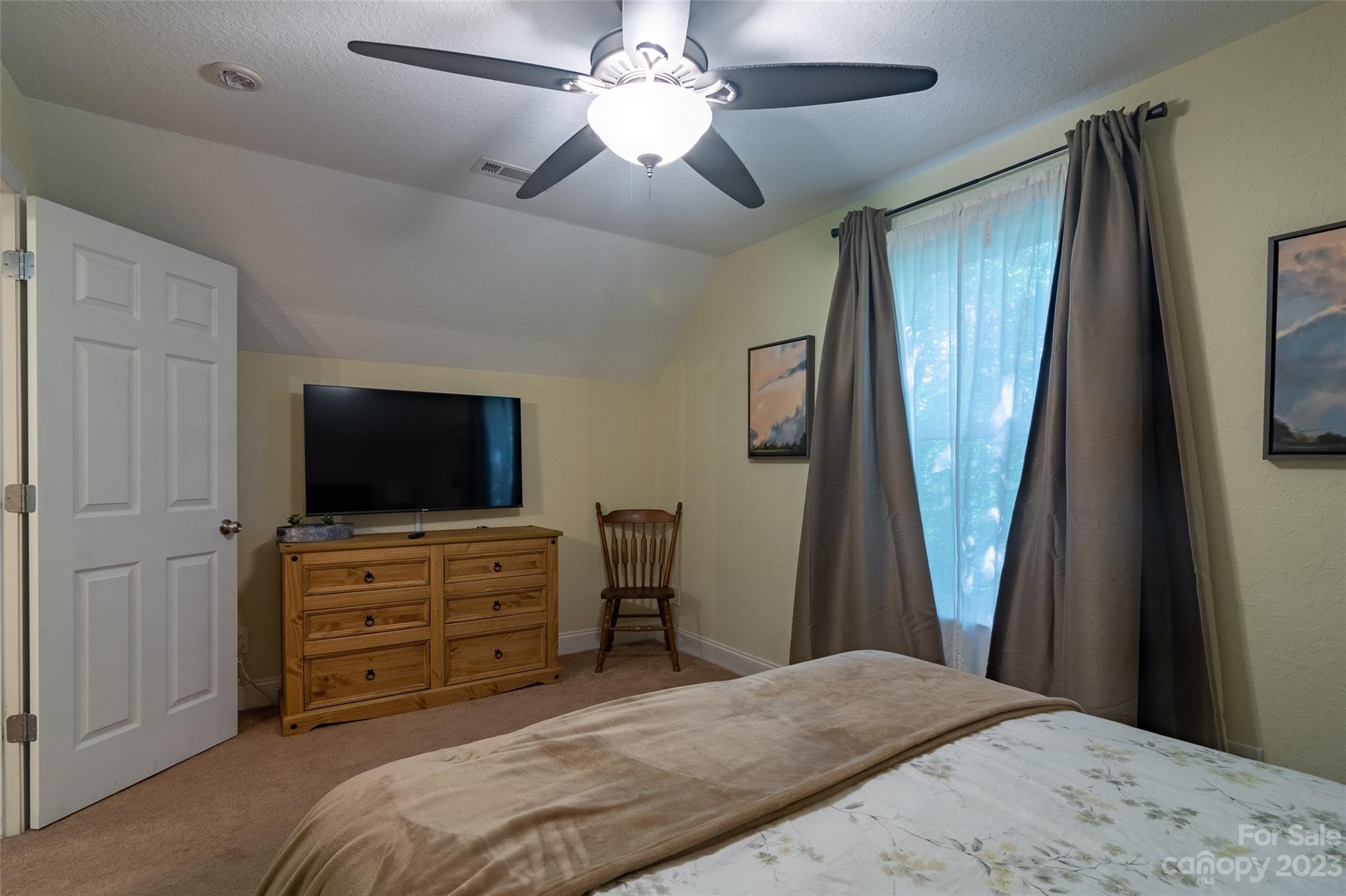 125 Parris Field Road Bryson City, NC 28713 - Photo 20 of 25 a bedroom with a bed and a flat screen tv