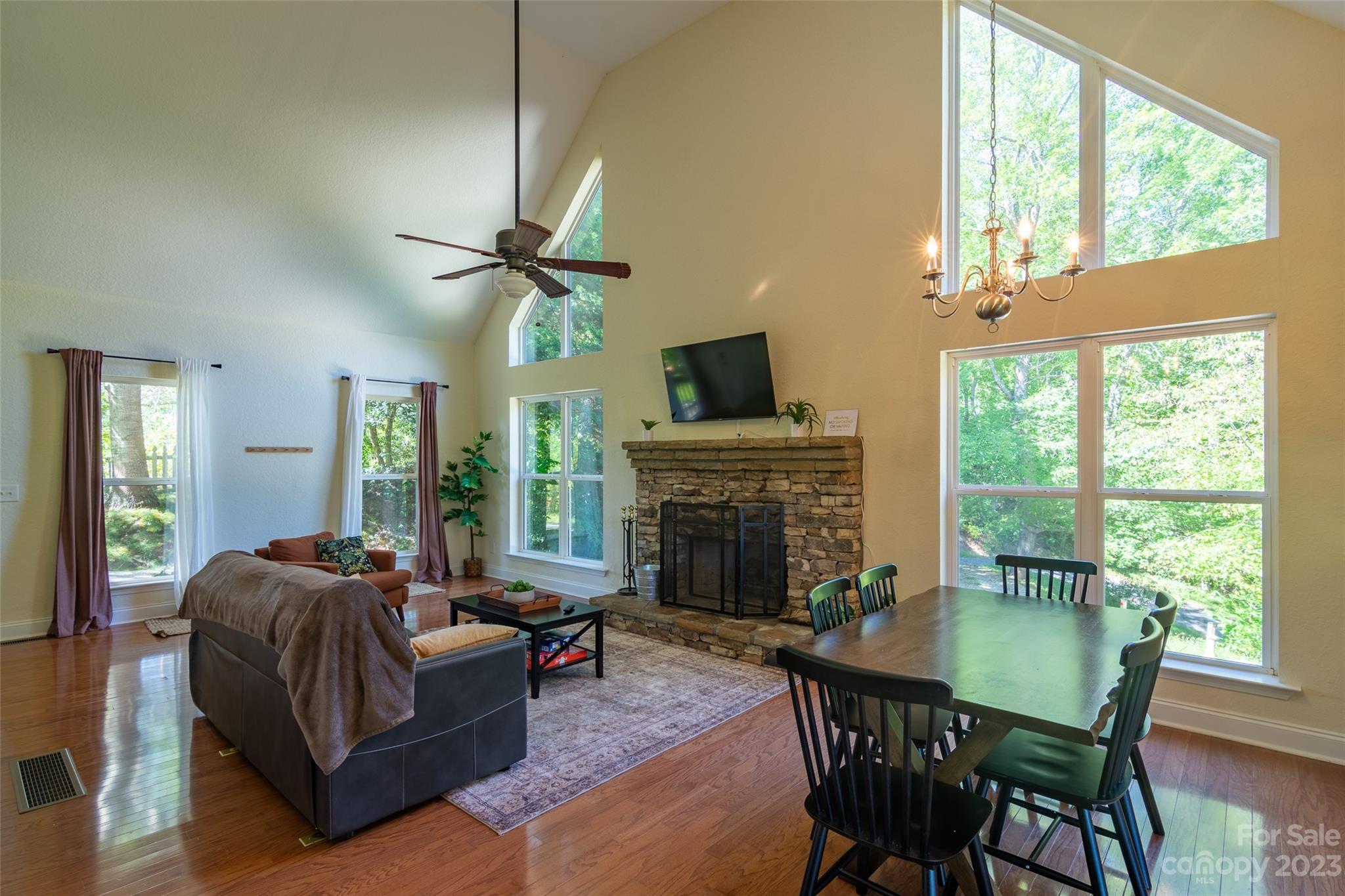 125 Parris Field Road Bryson City, NC 28713 - Photo 6 of 25 a living room with furniture a fireplace and a large window