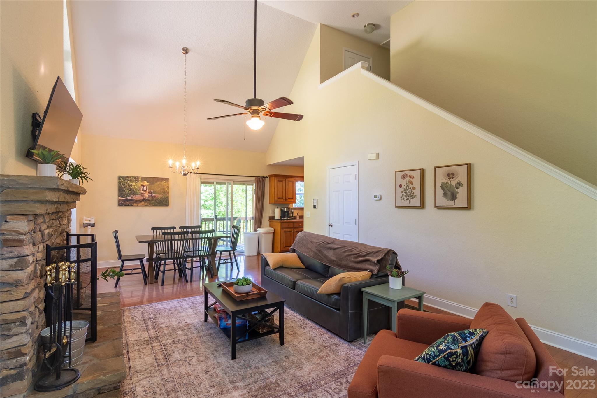 125 Parris Field Road Bryson City, NC 28713 - Photo 8 of 25 a living room with furniture a fireplace and a flat screen tv