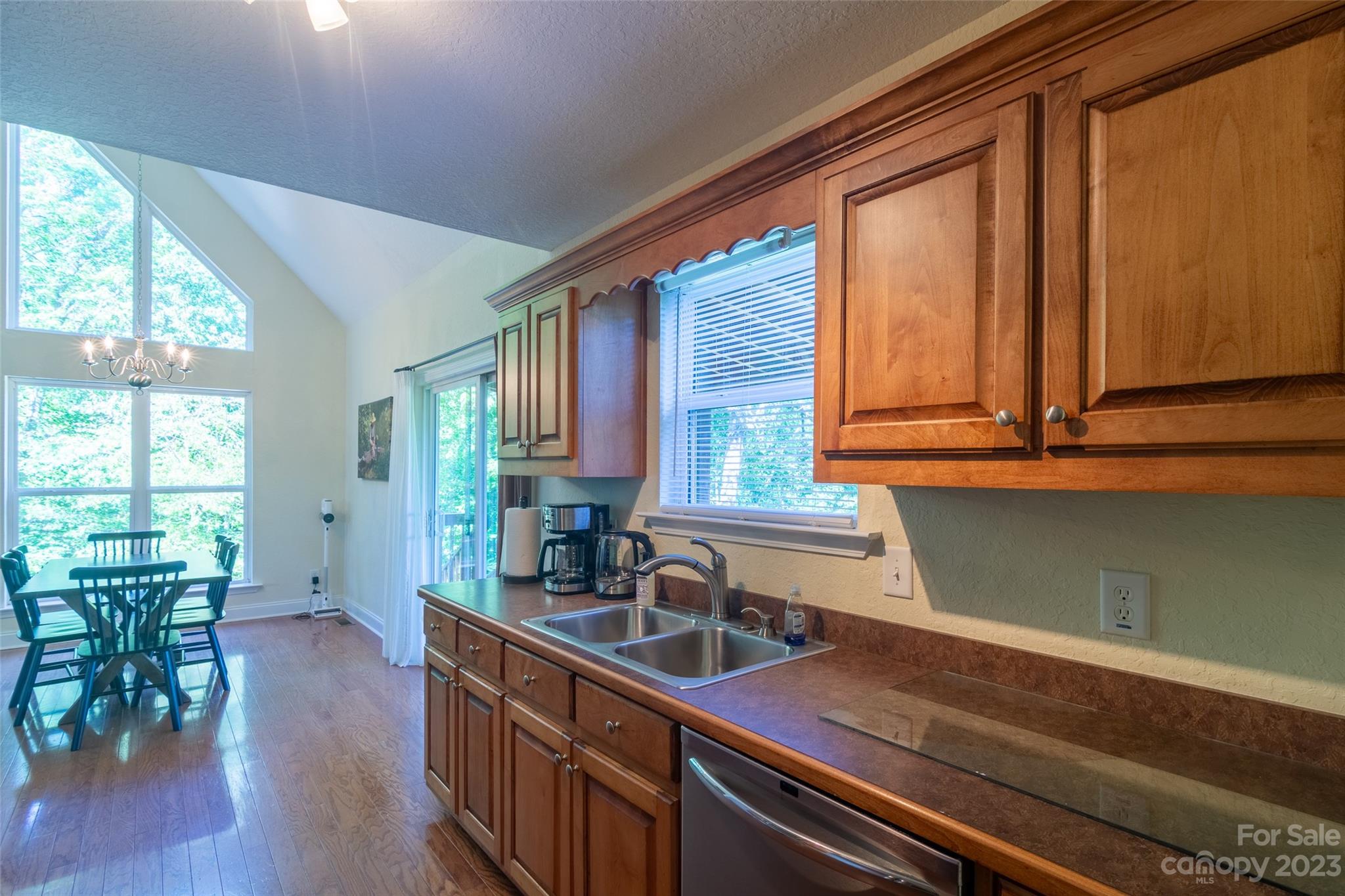 125 Parris Field Road Bryson City, NC 28713 - Photo 10 of 25 a kitchen with stainless steel appliances sink cabinets and wooden floor