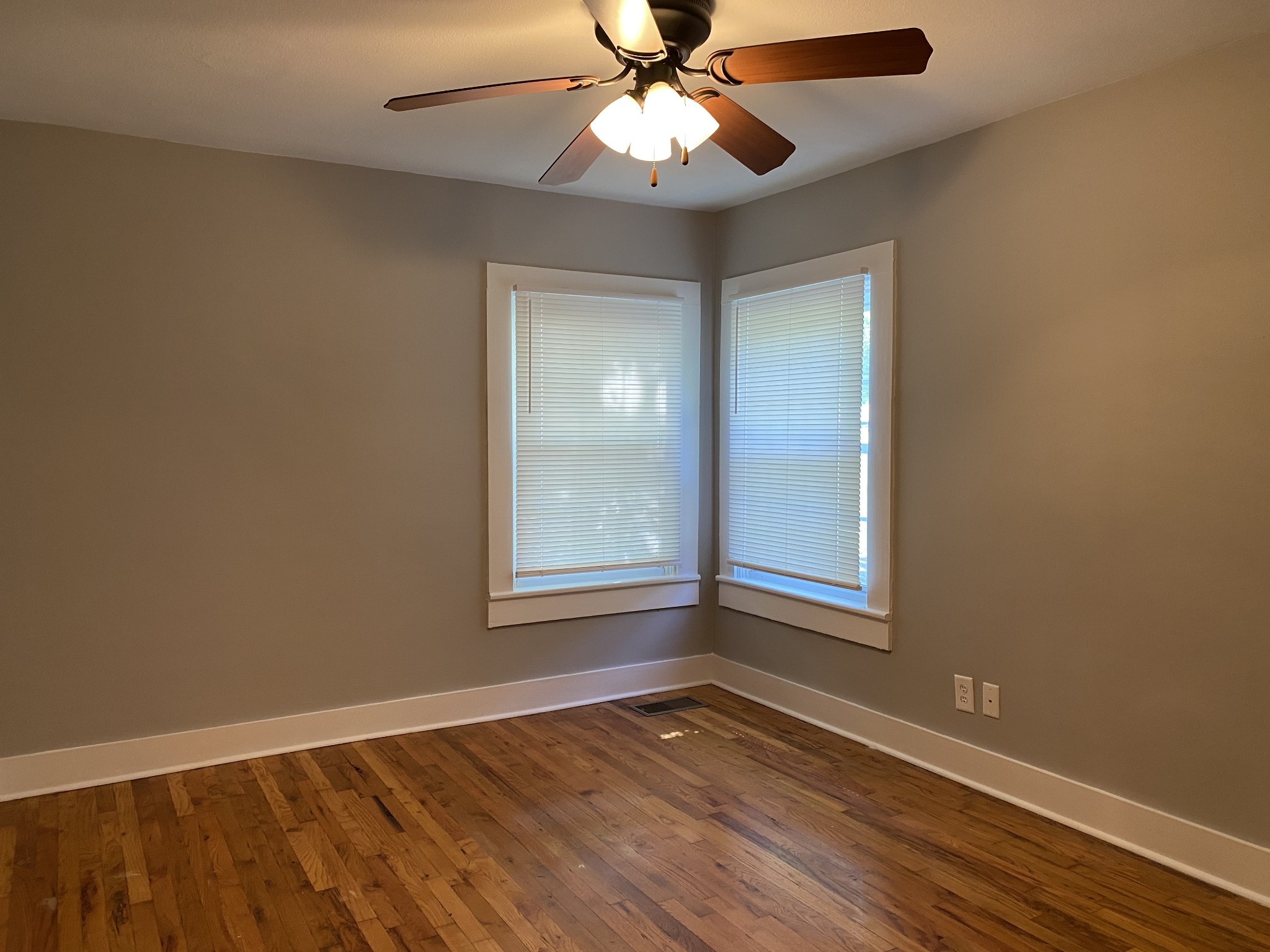 204 Rudolph Drive Clarksville, TN 37040 - Photo 14 of 19 an empty room with wooden floor chandelier fan and windows