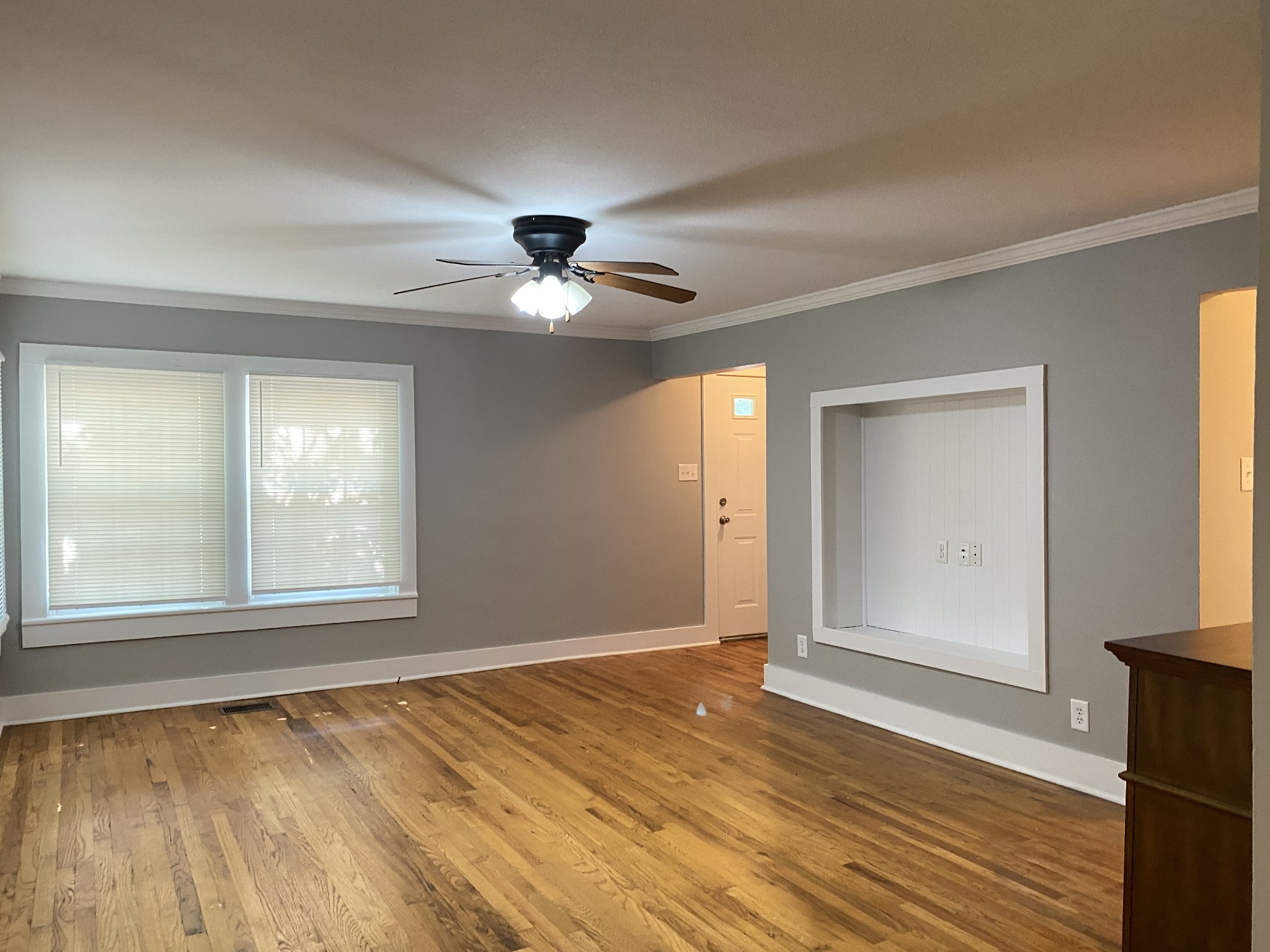 204 Rudolph Drive Clarksville, TN 37040 - Photo 6 of 19 an empty room with wooden floor fan and windows