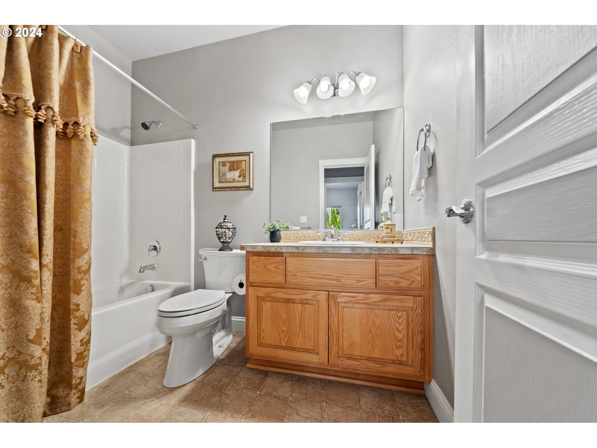 3779 Northwest 4th Way Hillsboro, OR 97124 - Photo 13 of 24 a bathroom with a toilet a sink and a mirror