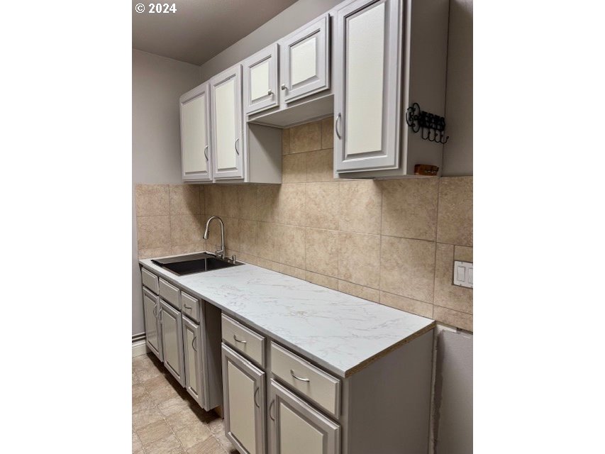 3779 Northwest 4th Way Hillsboro, OR 97124 - Photo 14 of 24 a kitchen with a sink and cabinets