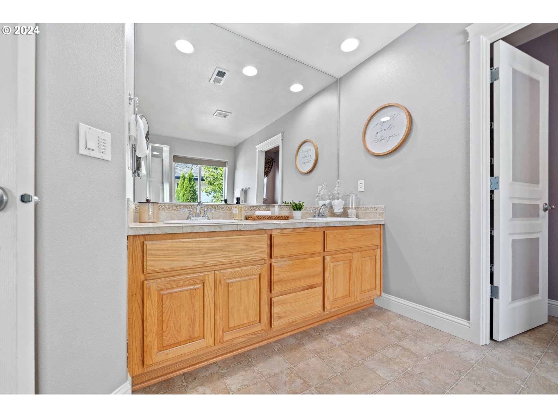 3779 Northwest 4th Way Hillsboro, OR 97124 - Photo 19 of 24 a bathroom with a sink a vanity a mirror and a window