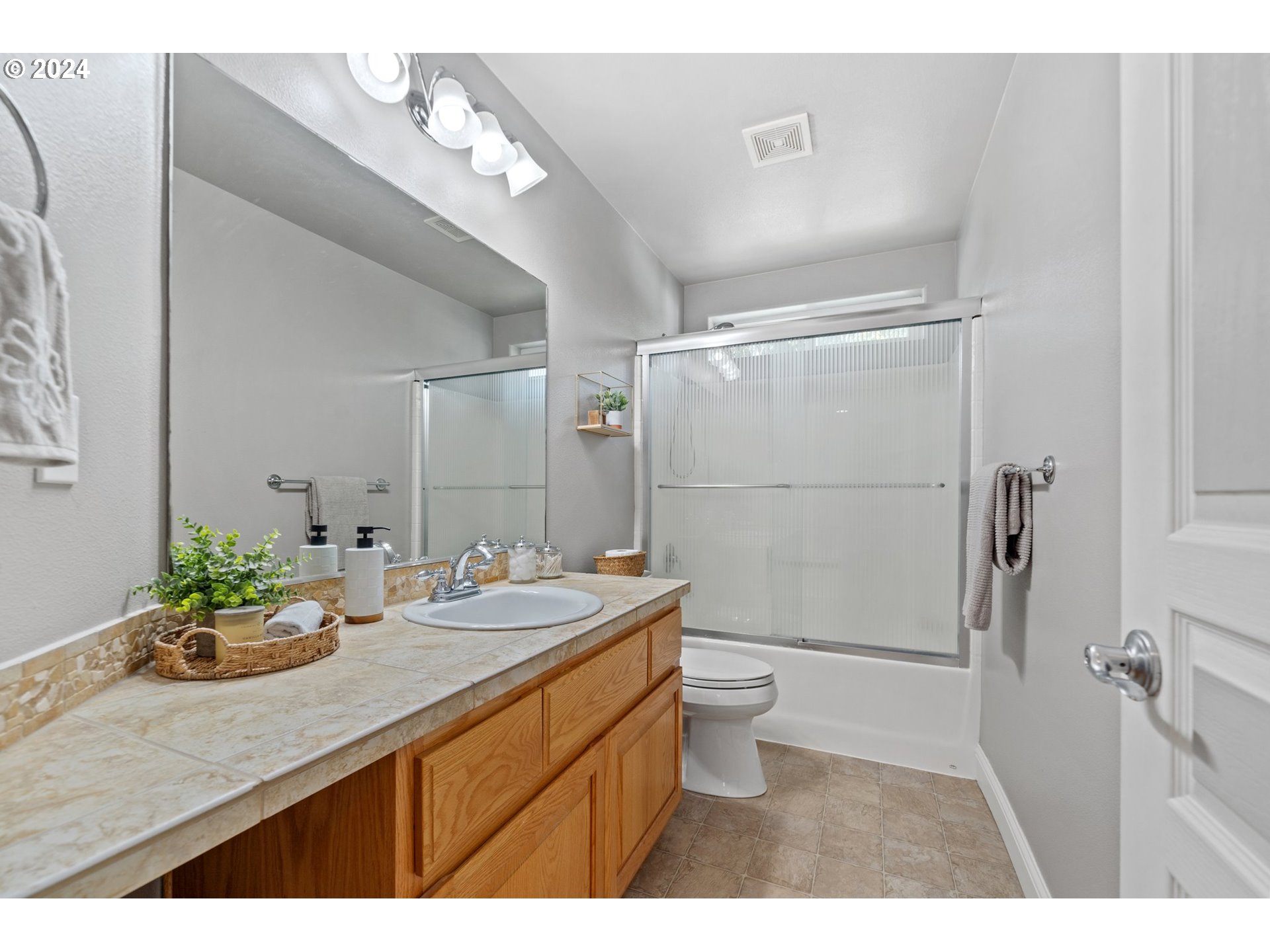 3779 Northwest 4th Way Hillsboro, OR 97124 - Photo 22 of 24 a bathroom with a sink a toilet and shower
