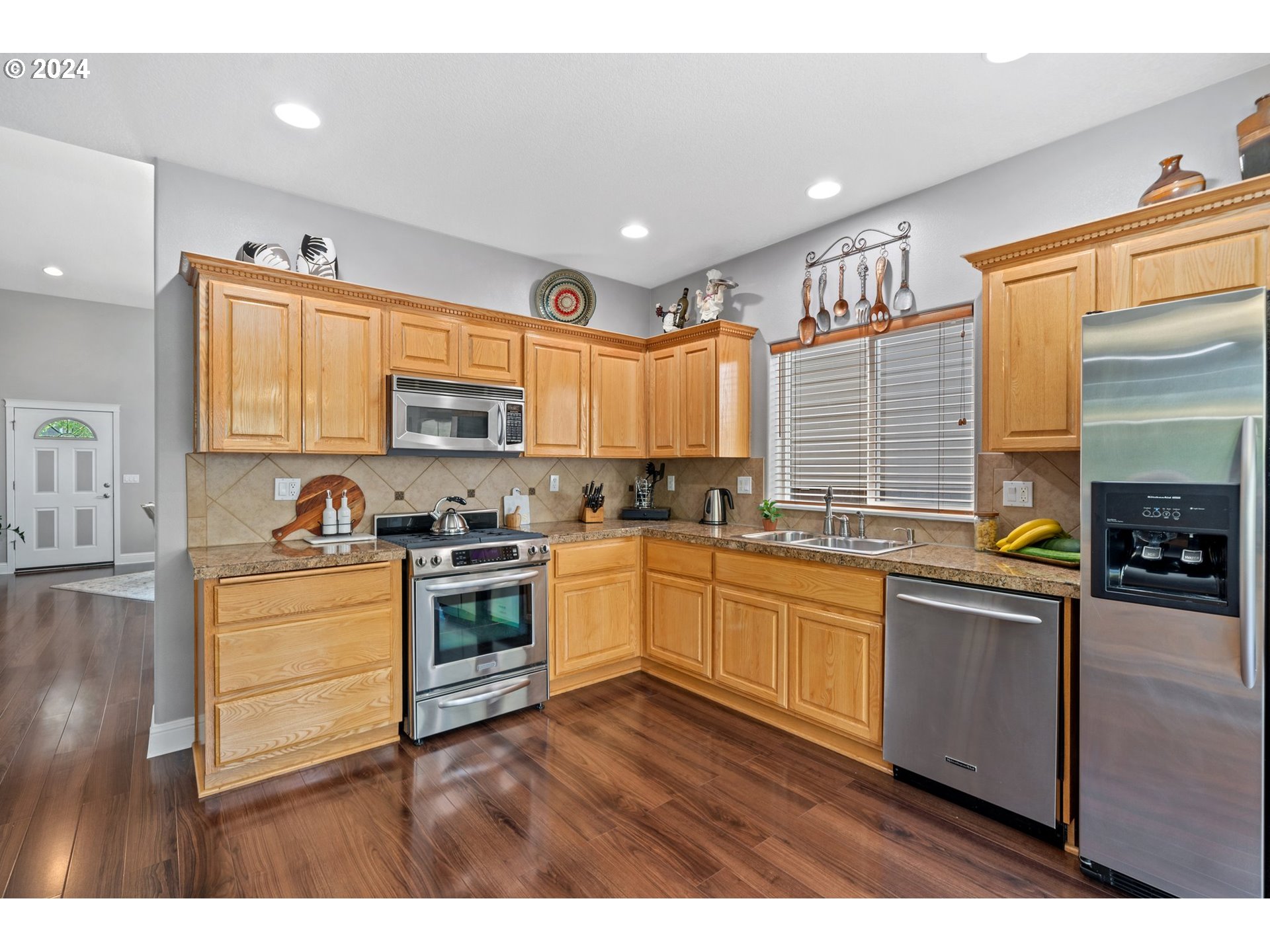 3779 Northwest 4th Way Hillsboro, OR 97124 - Photo 7 of 24 a kitchen with stainless steel appliances granite countertop a stove a sink and a microwave