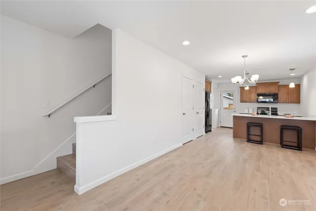 a view of kitchen with kitchen island white cabinets and refrigerator