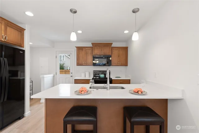 a kitchen with a dining table chairs sink and cabinets