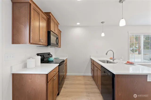 a kitchen with a sink stove and cabinets