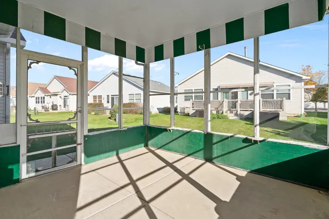 a view of a porch with a floor to ceiling windows