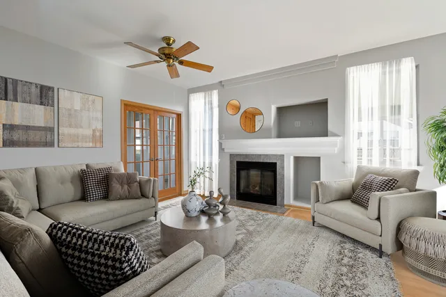 a living room with furniture a fireplace and a flat screen tv