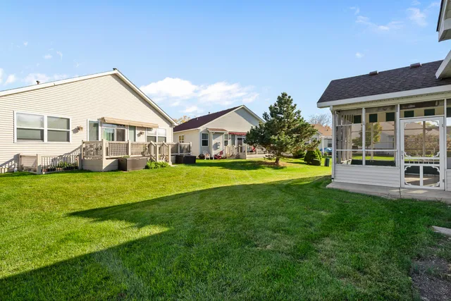 a view of a house with a big yard and potted plants