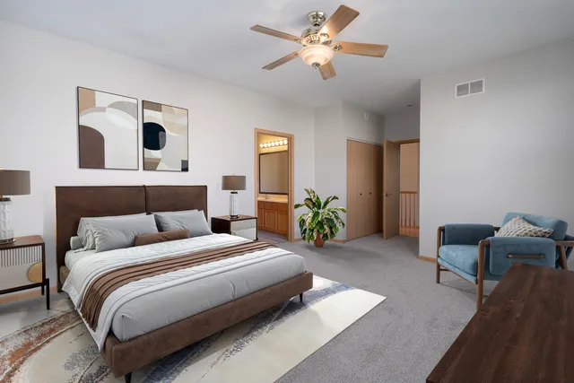 a bedroom with bed and a chandelier