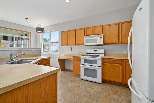 a kitchen with a stove a sink and a microwave