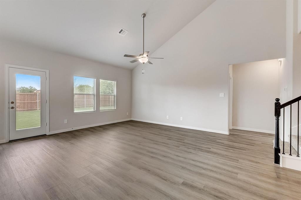 1405 Winters Way McKinney, TX 75071 - Photo 11 of 32 Unfurnished living room featuring high vaulted ceiling, light hardwood / wood-style floors, and ceiling fan