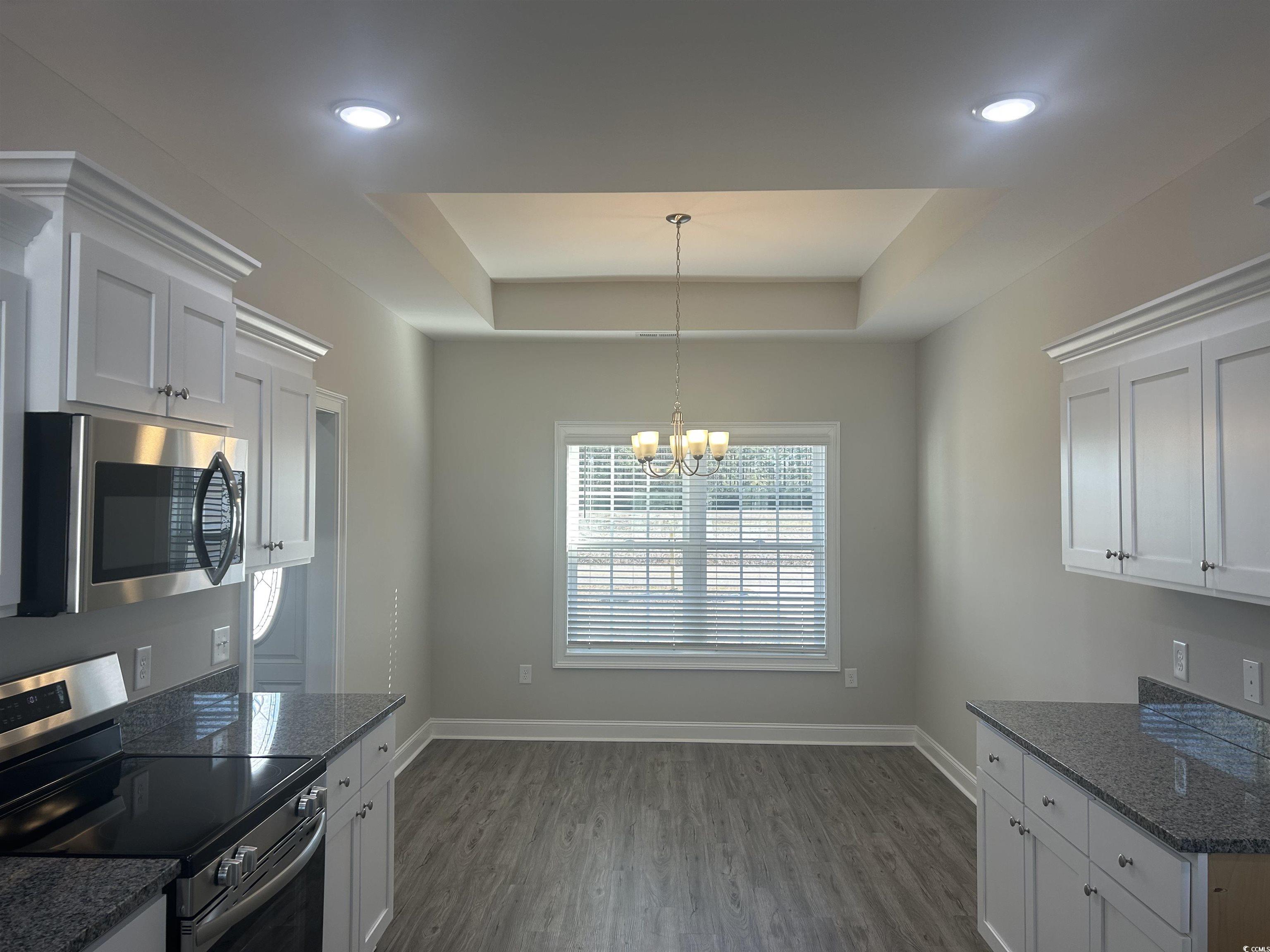 2347 King Farm Road Aynor, SC 29511 - Photo 5 of 36 Kitchen with a tray ceiling, white cabinets, and s