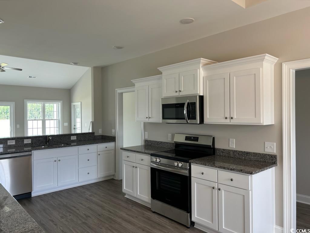 2347 King Farm Road Aynor, SC 29511 - Photo 6 of 36 Kitchen with dark wood-type flooring, white cabine