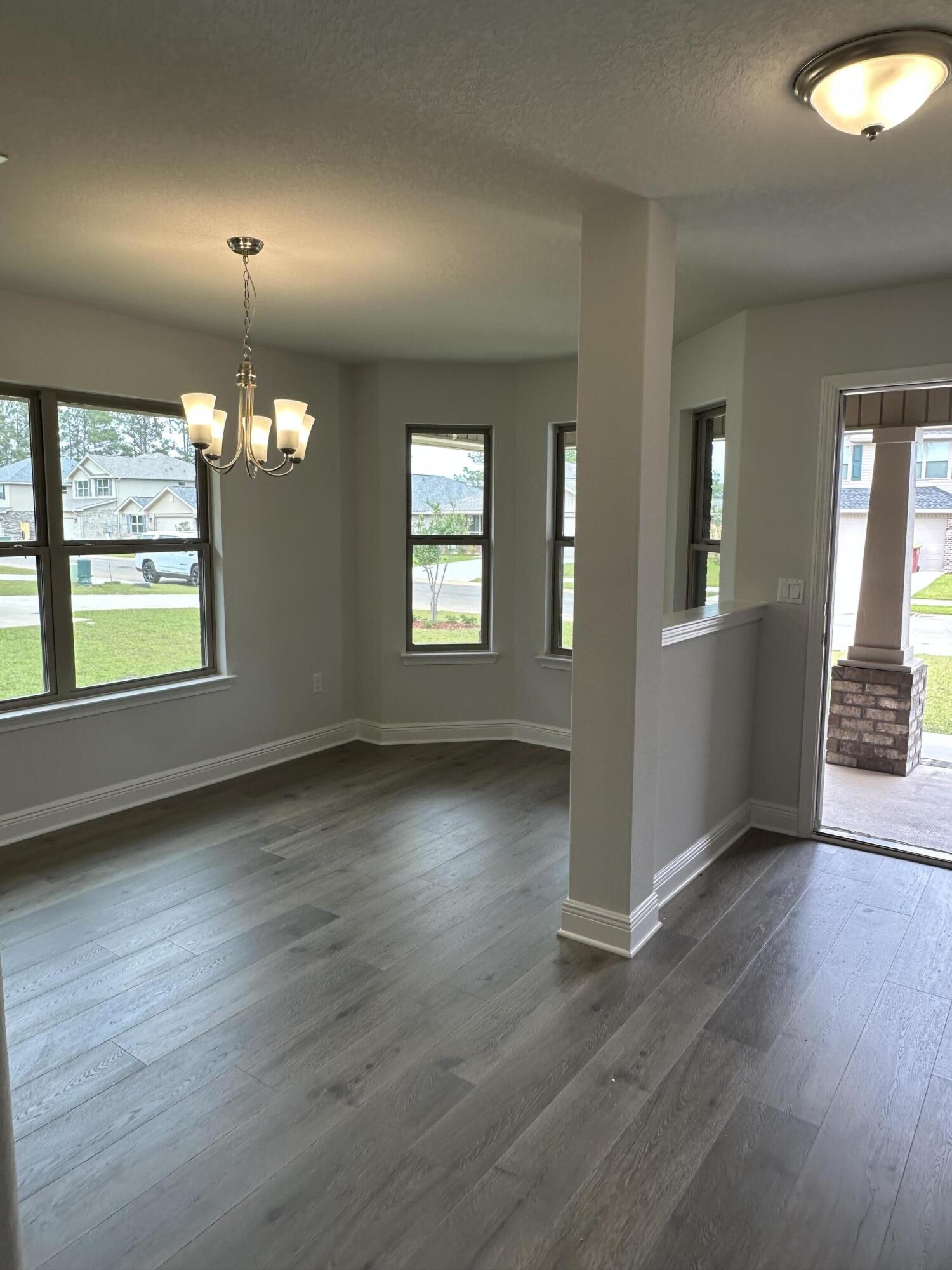 187 Ridgeway Circle Crestview, FL 32536 - Photo 5 of 22 an empty room with wooden floor and windows