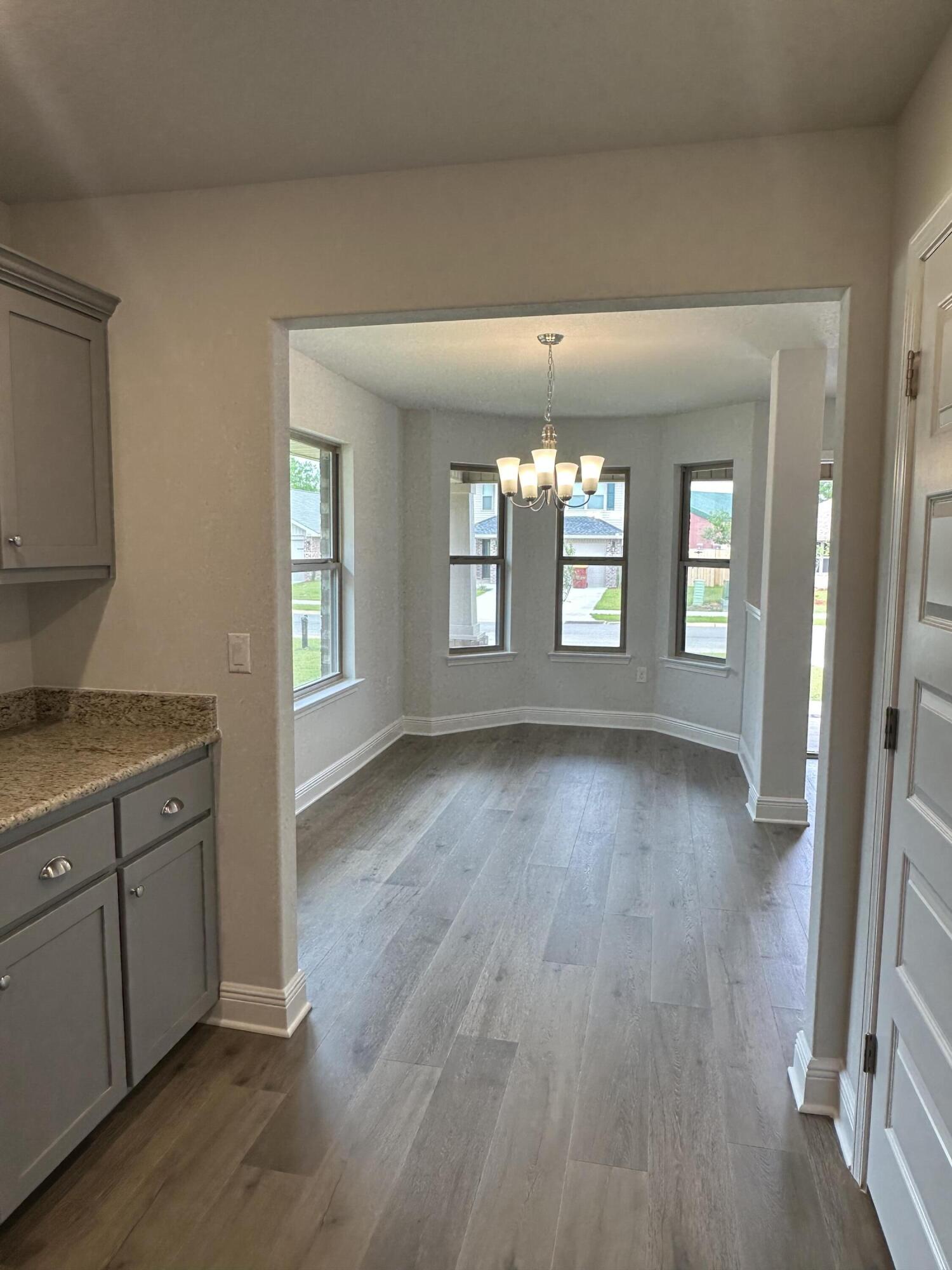 187 Ridgeway Circle Crestview, FL 32536 - Photo 6 of 22 a view of an empty room and window and wooden floor