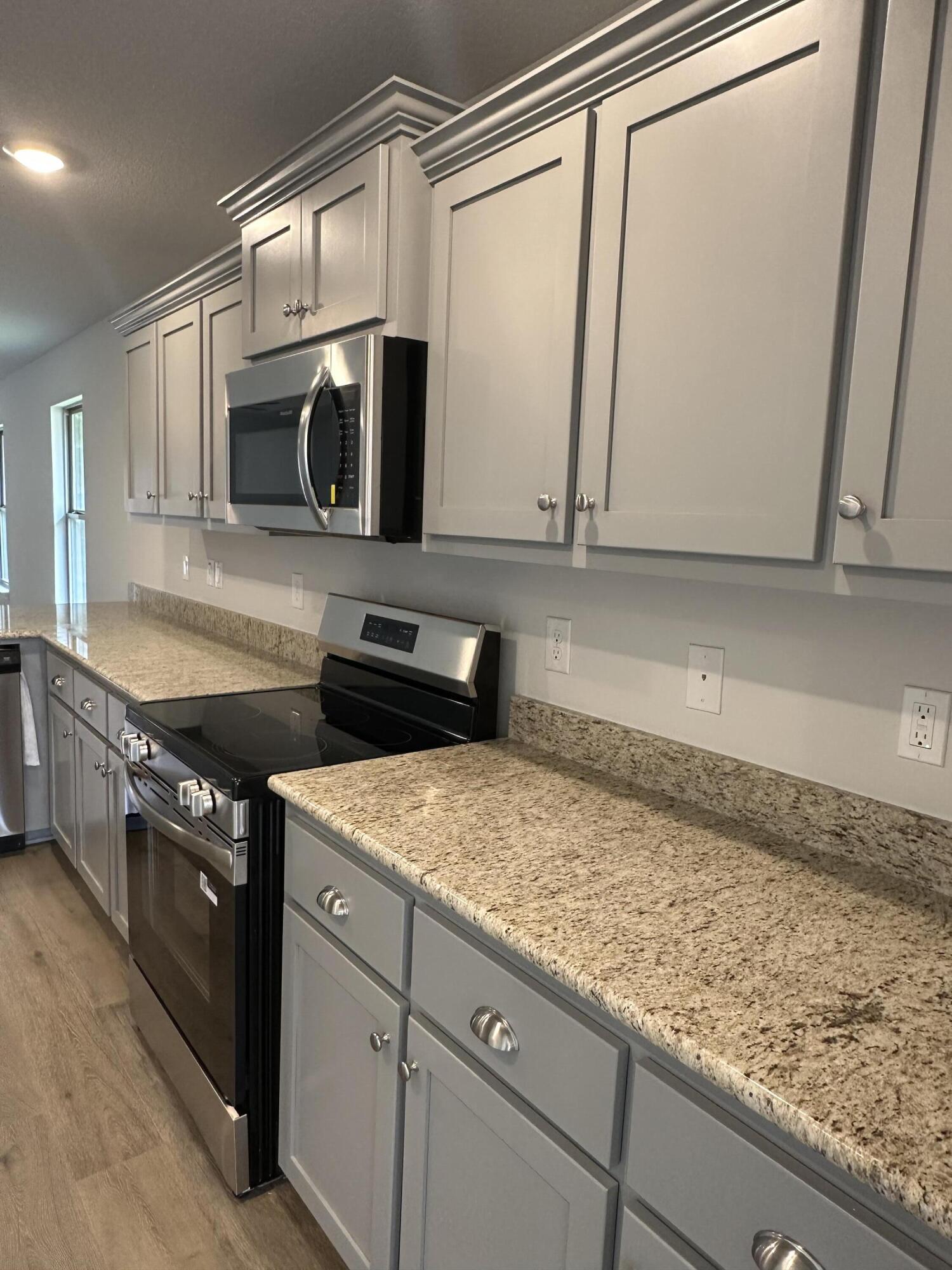 187 Ridgeway Circle Crestview, FL 32536 - Photo 9 of 22 a kitchen with stainless steel appliances granite countertop a sink and a microwave