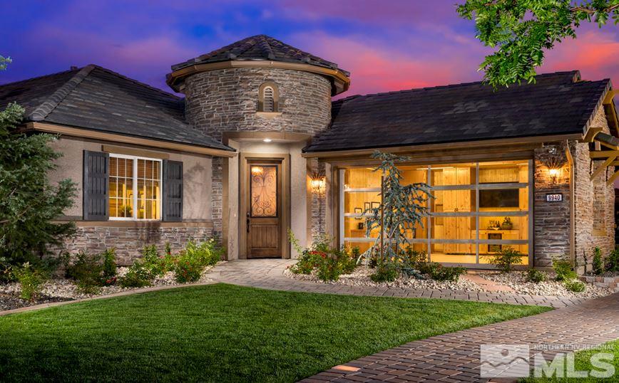 9940 Hafflinger Lane, Unit STONY RIDGE Reno, NV 89521 - Photo 1 of 17 a front view of a house with garden