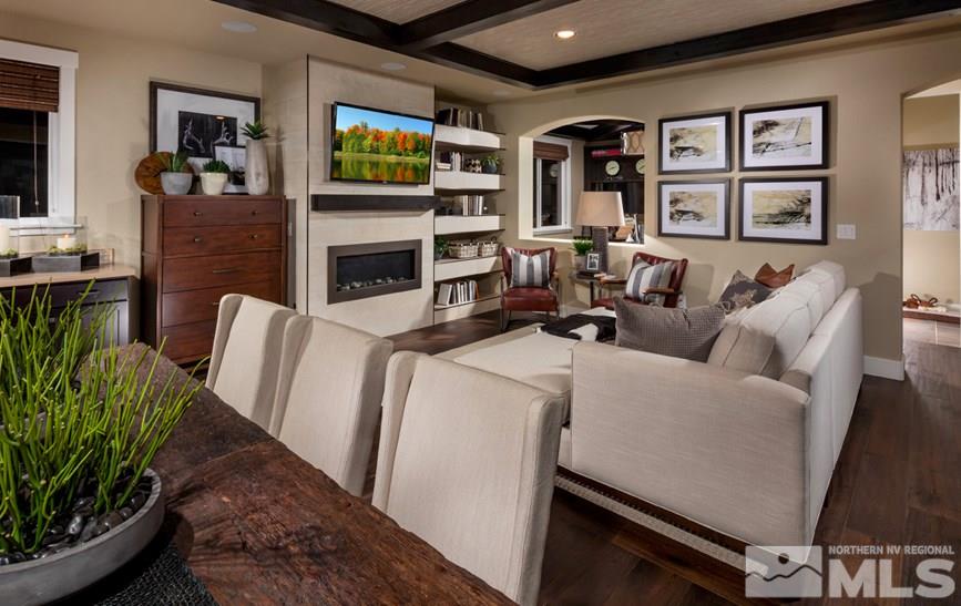 9940 Hafflinger Lane, Unit STONY RIDGE Reno, NV 89521 - Photo 2 of 17 a living room with furniture a flat screen tv and a fireplace