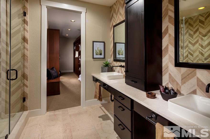 9940 Hafflinger Lane, Unit STONY RIDGE Reno, NV 89521 - Photo 5 of 17 a bathroom with a double vanity sink and a mirror