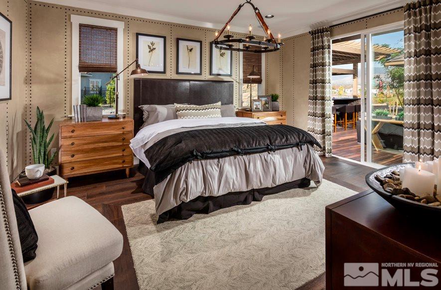 9940 Hafflinger Lane, Unit STONY RIDGE Reno, NV 89521 - Photo 6 of 17 a bedroom with a bed and wooden floor