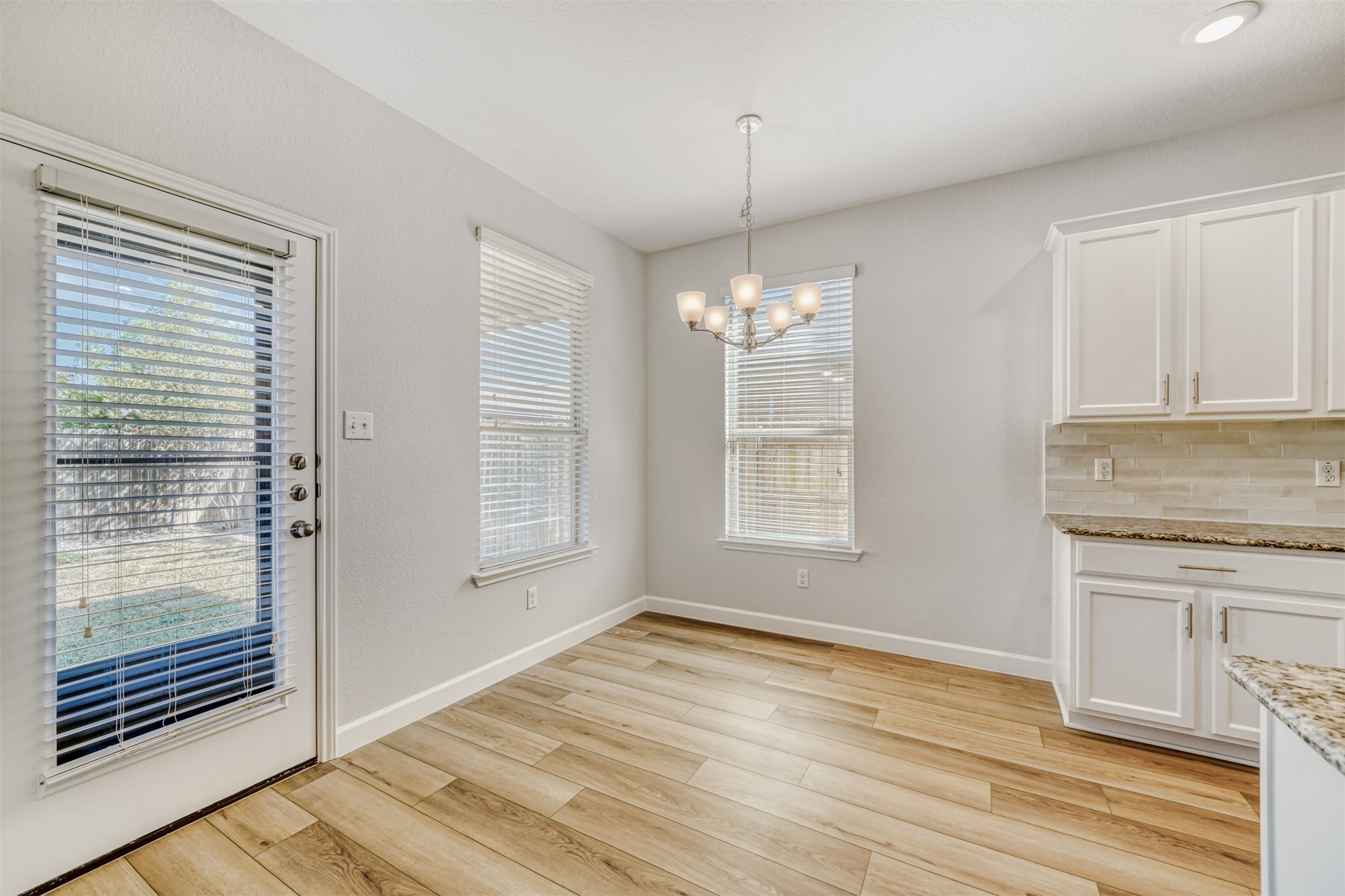 301 Serpentine Lane Jarrell, TX 76537 - Photo 12 of 39 a view of an empty room with a window and wooden floor