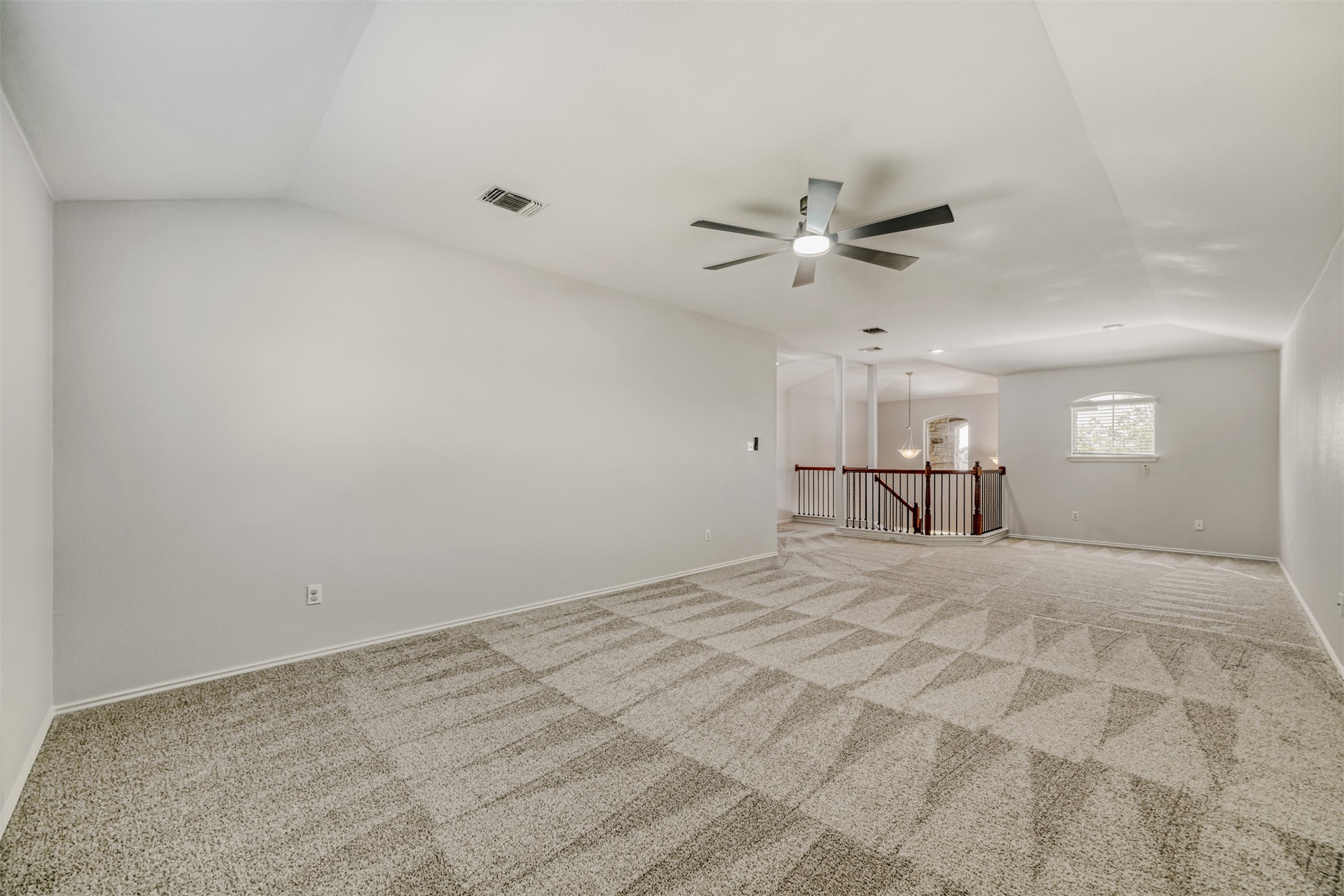 301 Serpentine Lane Jarrell, TX 76537 - Photo 14 of 39 a view of a room with an empty space and a ceiling fan