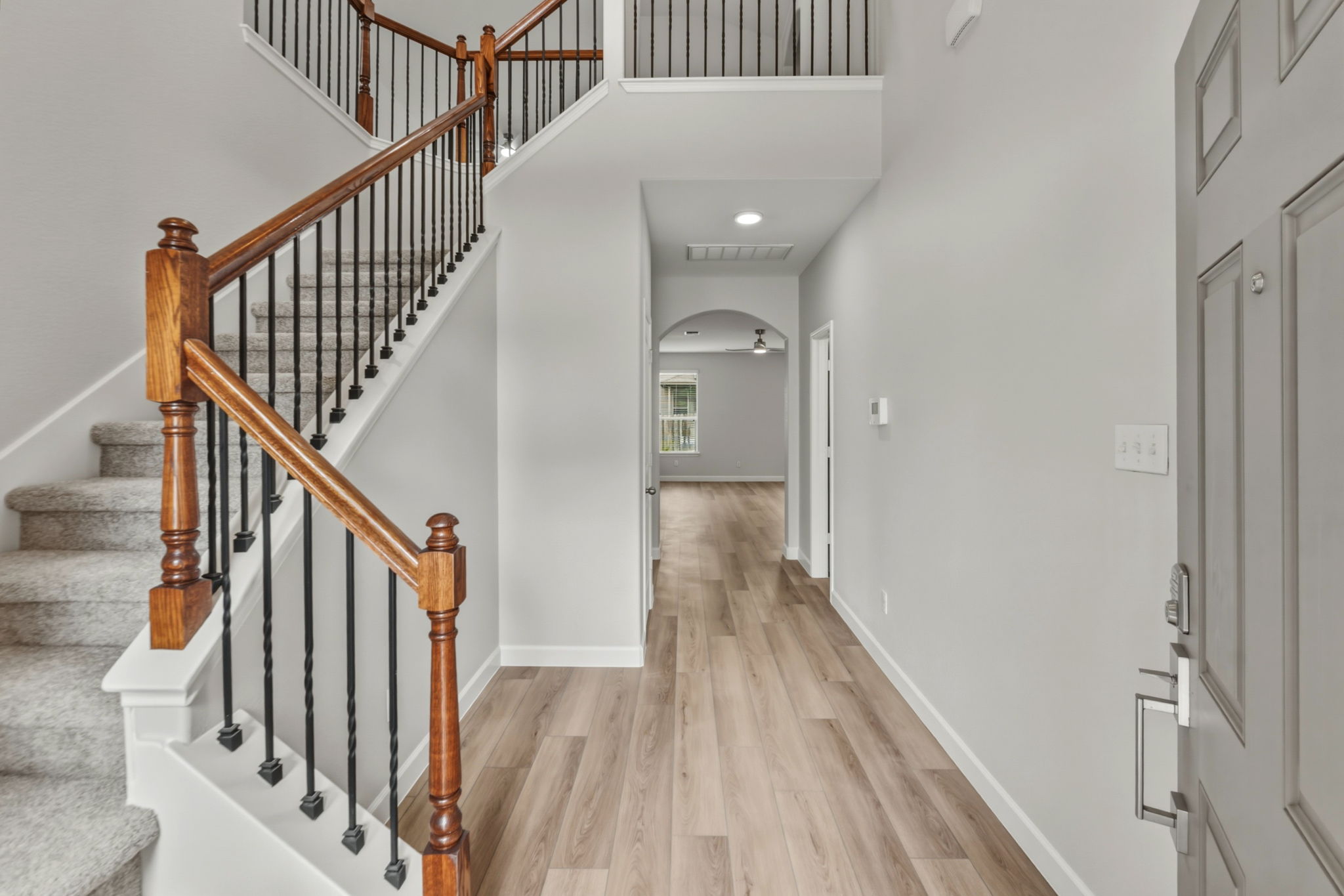301 Serpentine Lane Jarrell, TX 76537 - Photo 3 of 39 a view of staircase with wooden floor and white walls