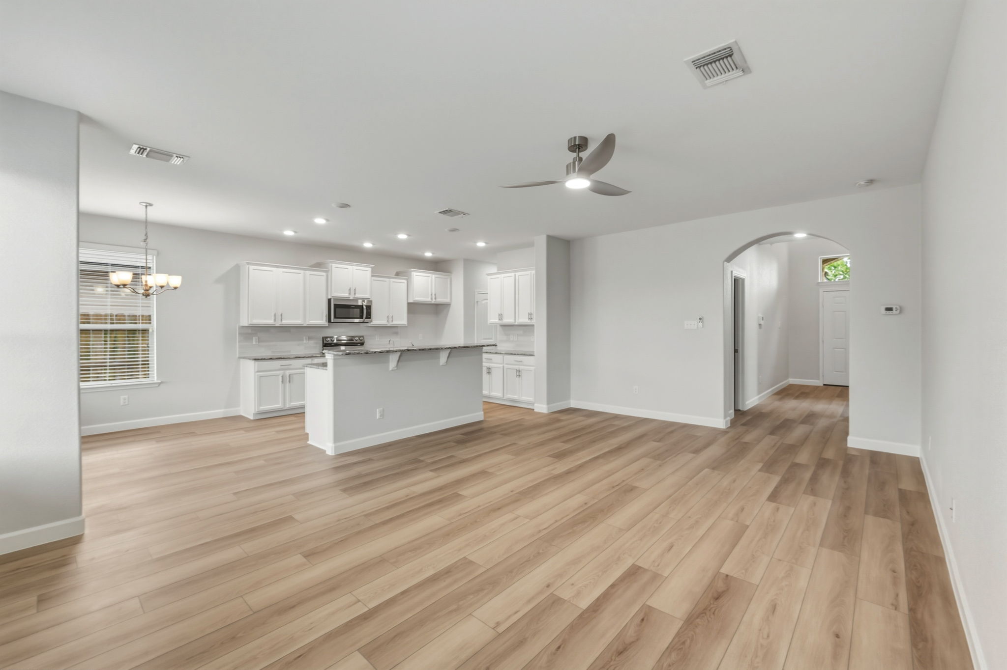 301 Serpentine Lane Jarrell, TX 76537 - Photo 4 of 39 a view of kitchen with wooden floor and windows
