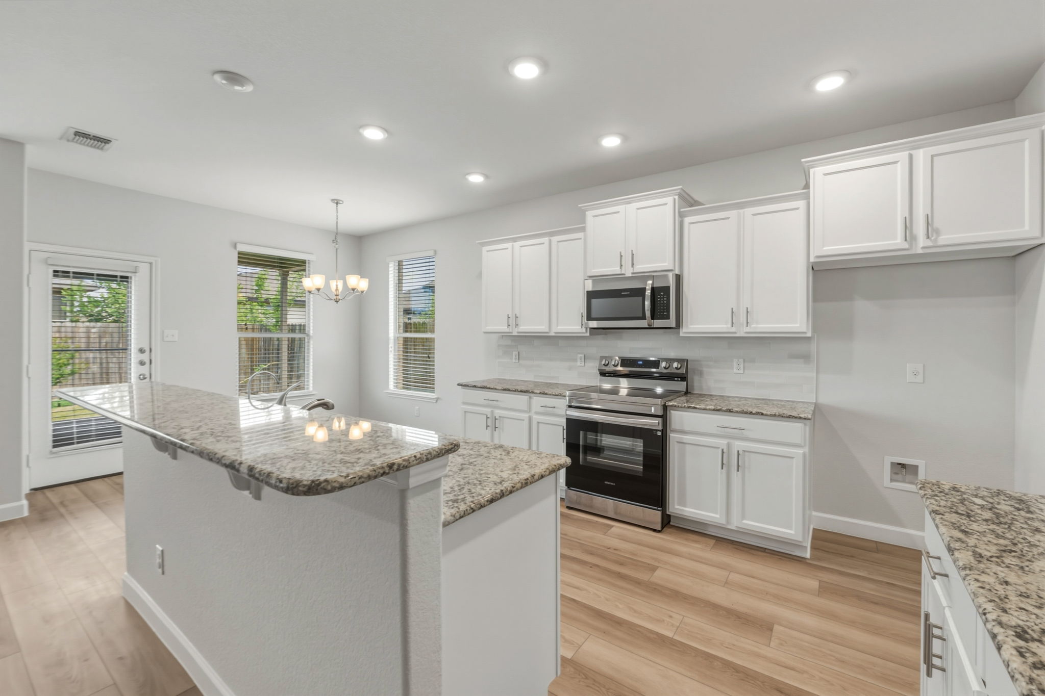 301 Serpentine Lane Jarrell, TX 76537 - Photo 6 of 39 a kitchen with stainless steel appliances granite countertop a stove a sink and a refrigerator