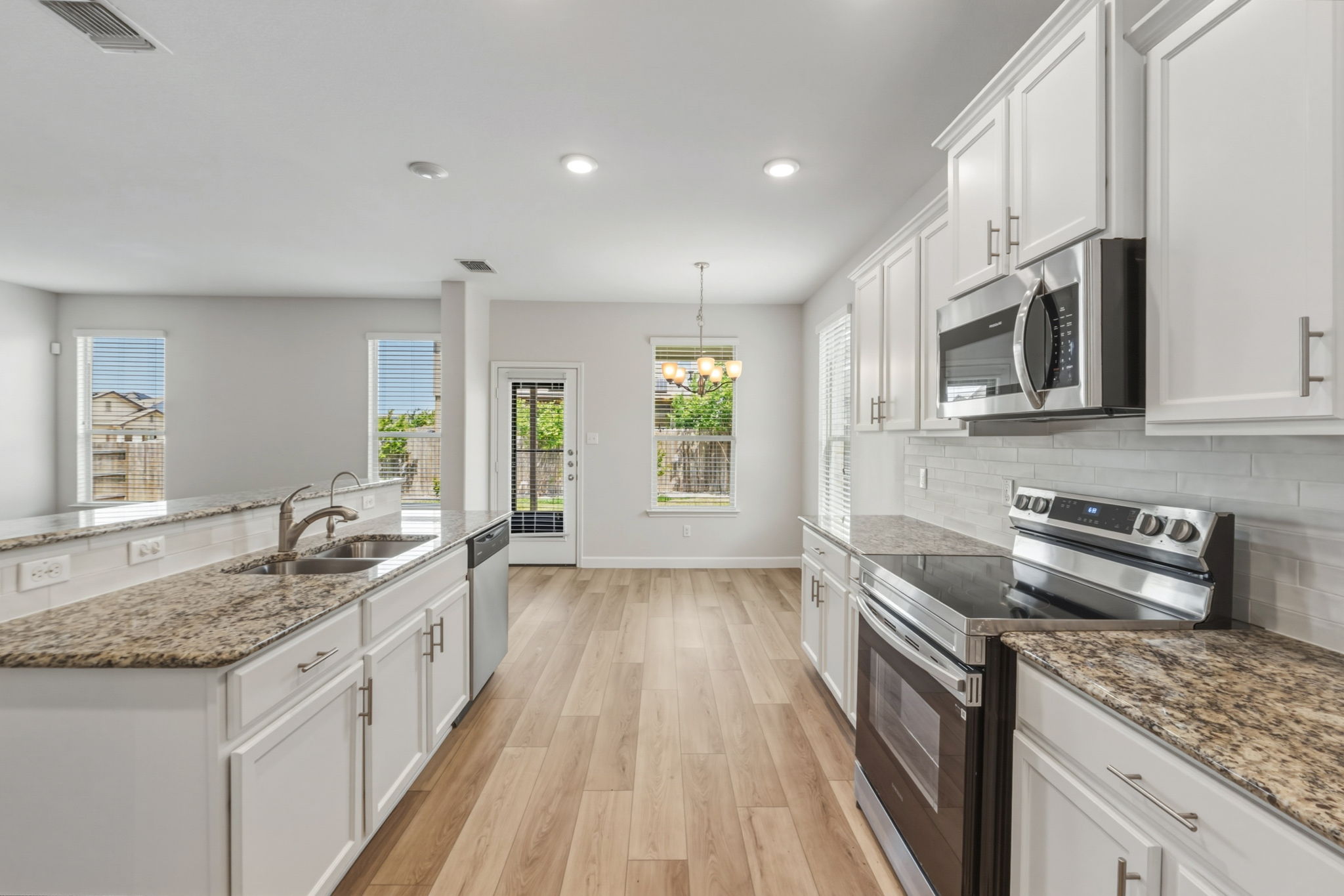 301 Serpentine Lane Jarrell, TX 76537 - Photo 7 of 39 a kitchen with stainless steel appliances granite countertop a sink stove and cabinets