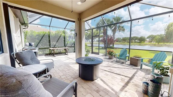 a living room with patio furniture and a potted plant