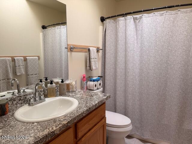 1147 White Oak Loop Minden, NV 89423 - Photo 15 of 23 a bathroom with a granite countertop sink toilet and a mirror