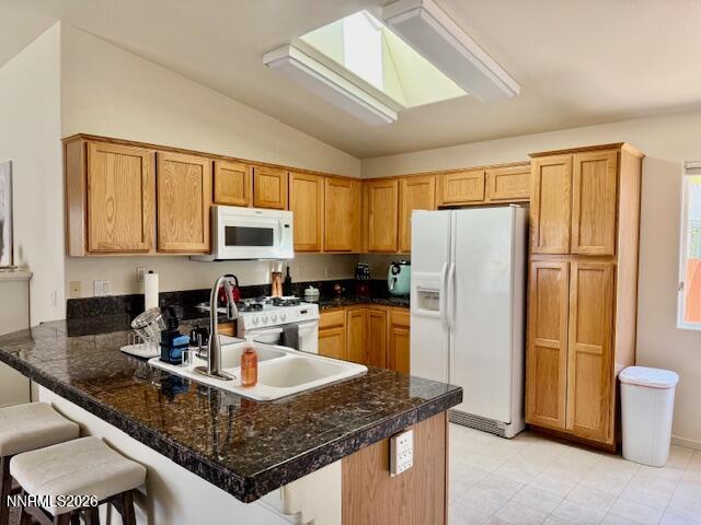 1147 White Oak Loop Minden, NV 89423 - Photo 8 of 23 a kitchen with granite countertop a refrigerator a stove a sink a dining table and chairs
