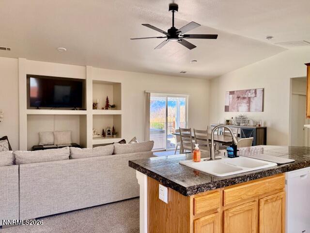 1147 White Oak Loop Minden, NV 89423 - Photo 10 of 23 a kitchen with a stove center island with furniture and a flat screen tv
