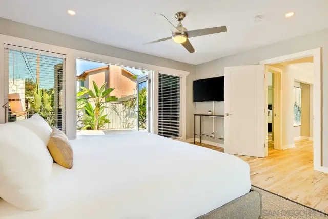 a bedroom with a large bed and a large window