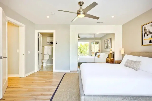 a bathroom with a granite countertop sink a toilet and a shower