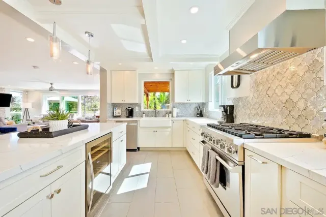 a kitchen with stainless steel appliances kitchen island granite countertop a refrigerator and a stove top oven