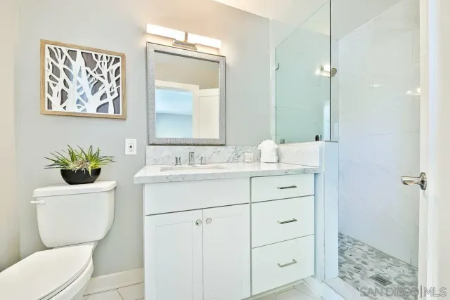 a room with a bed and a potted plant