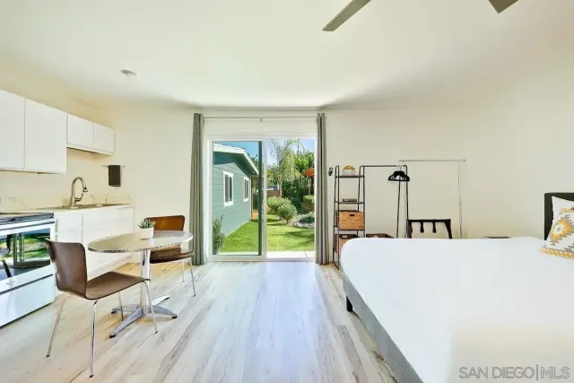 a bed sitting in a bedroom next to a lamp