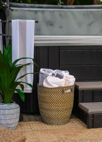 a view of a chair and tables in the back yard of the house