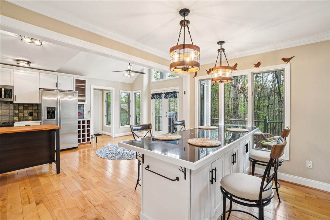 120 Beacon Ridge Circle Salem, SC 29676 - Photo 6 of 48 This kitchen offers a spacious layout with a central island and large windows overlooking lush greenery.
